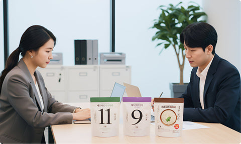 a woman and her colleagues working with haechomiin noodles displayed